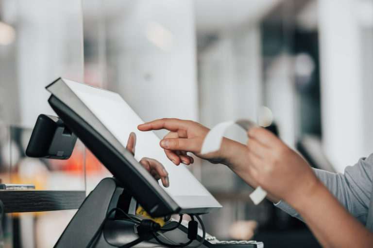 young-saleswoman-doing-process-payment-touchscreen-pos-counting-sale-cash-register-finance-concept-768x512